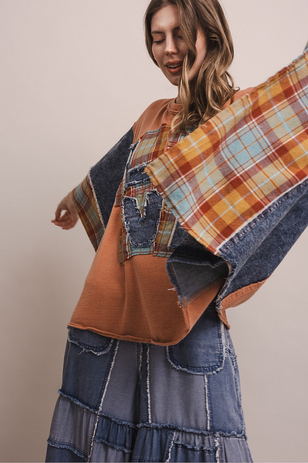 Bluevelvet coral poncho top with mixed denim and plaid sleeves, three-quarter angle on model, full-length view

