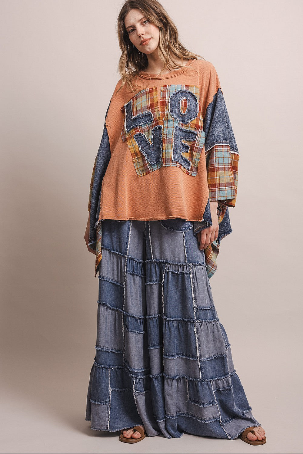 Bluevelvet coral patchwork poncho top with LOVE appliqué, side view showing plaid and denim sleeve panels on model

