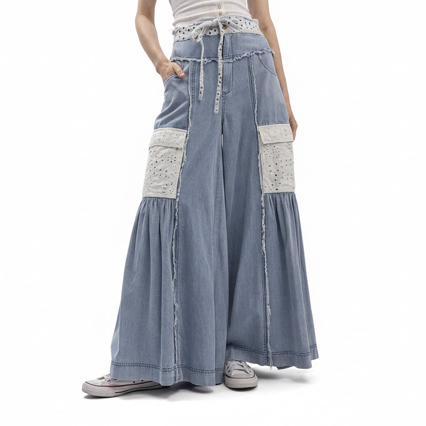 Long denim skirt with white patches on a plain background