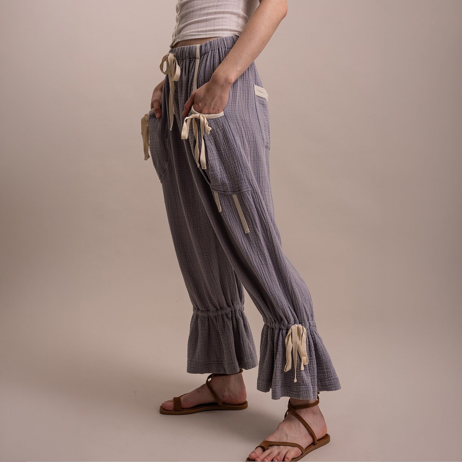 Bluevelvet women's denim blue bloomer pants, side view showing crinkle texture, side pocket, and ruffle ankle hem

