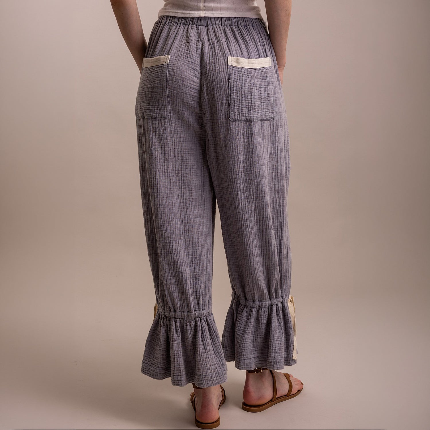 Bluevelvet women's denim blue bloomer pants, back view showing back pockets, crinkle texture, and ruffle hem
