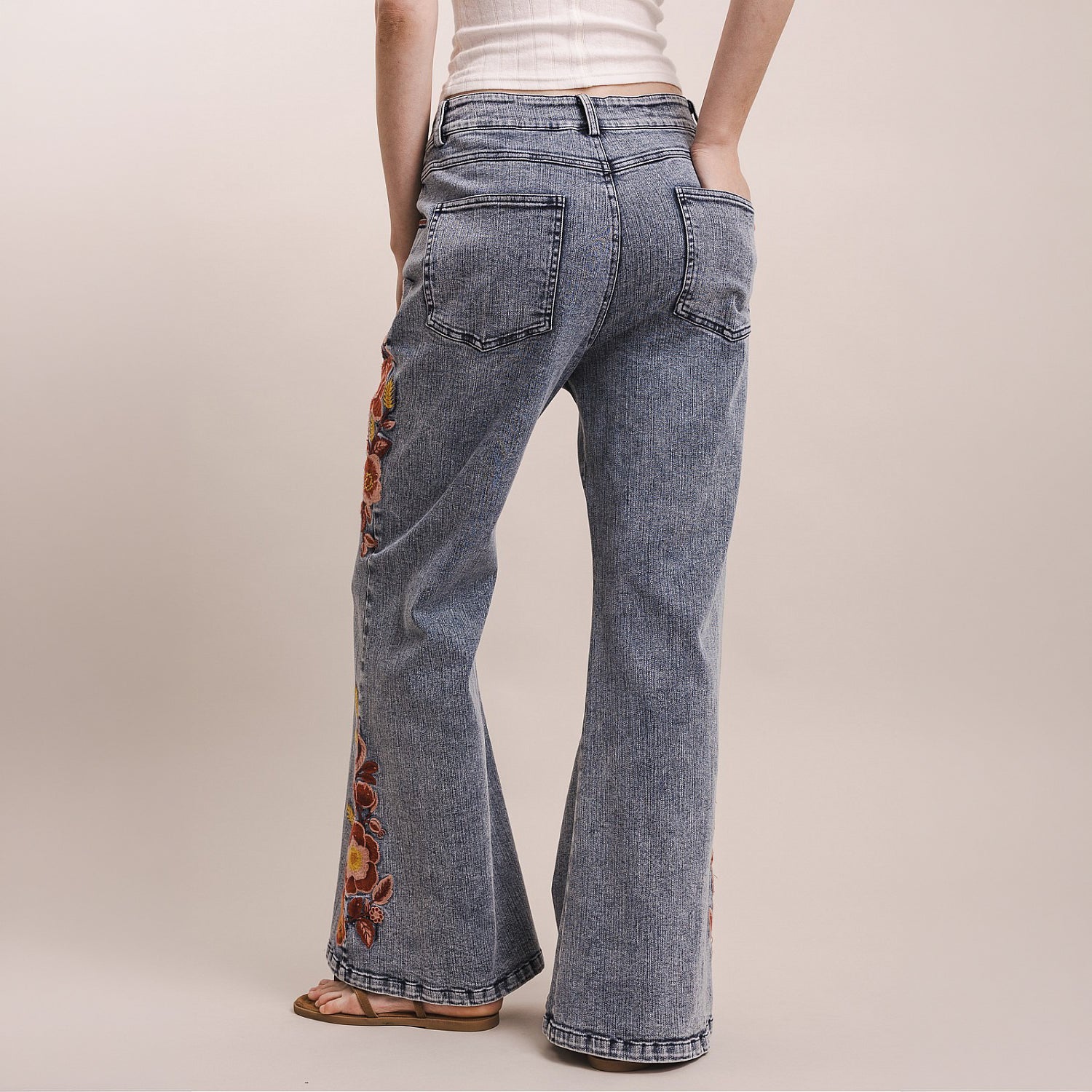Bluevelvet women's wide-leg denim pants back view showing patch pockets and floral embroidery at sides
