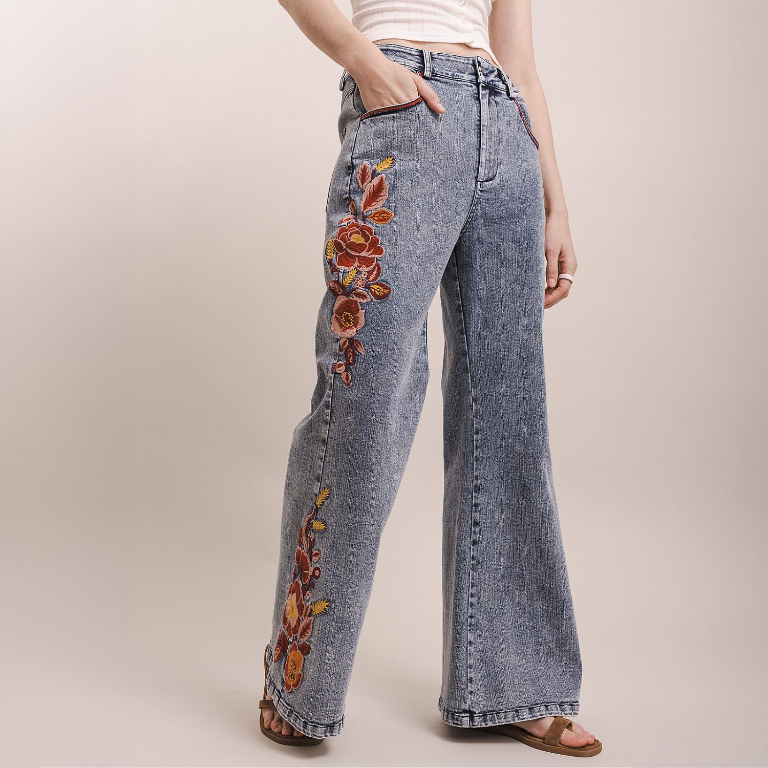 Bluevelvet women's denim wide-leg pants, side view showing rust and terracotta floral embroidery detail
