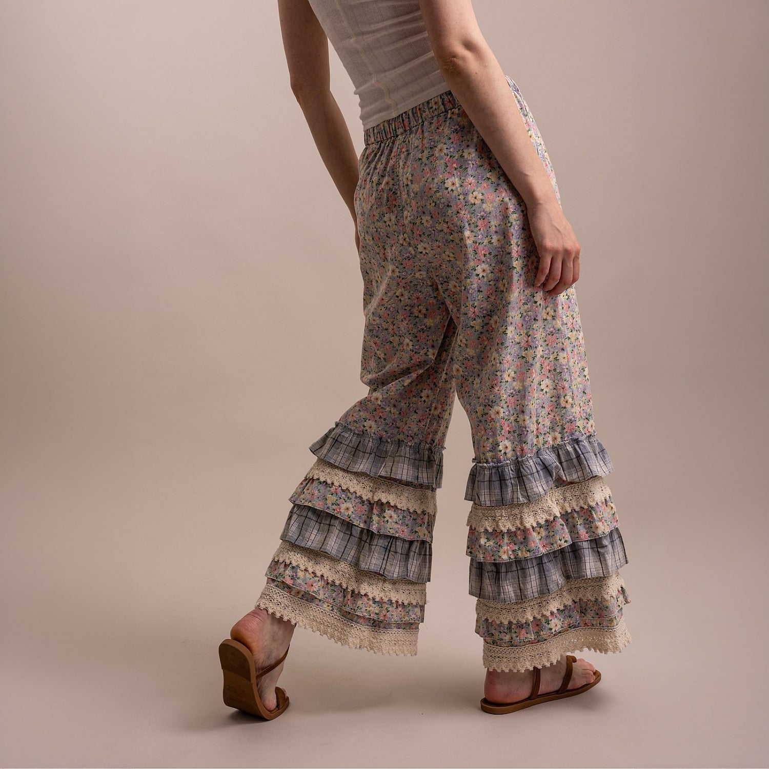 Bluevelvet floral ruffle wide leg pants, back walking view, tiered ruffle hem detail
