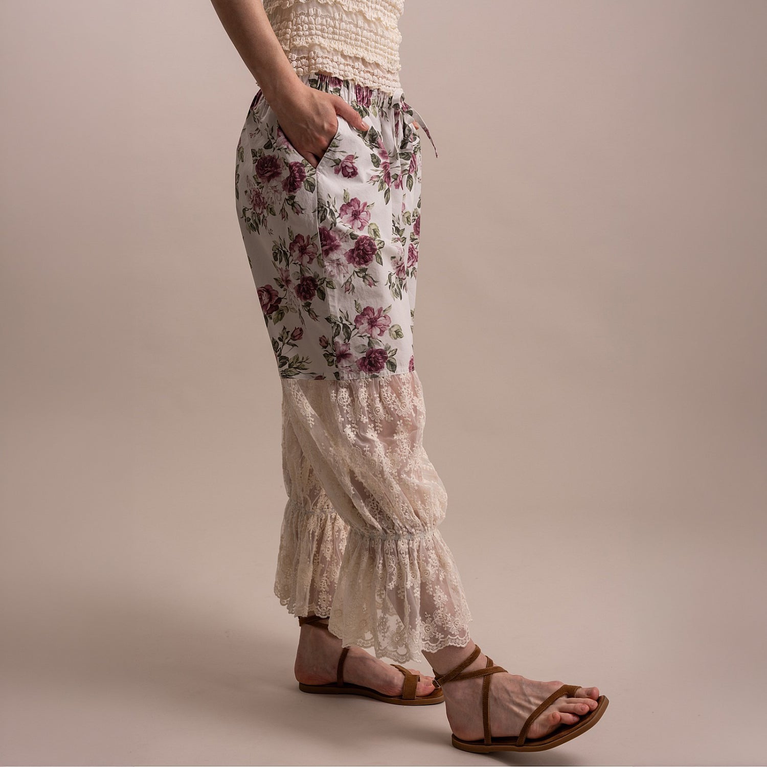 Bluevelvet women's off white floral pants, side view showing lace panel volume and ruffle cuff silhouette
