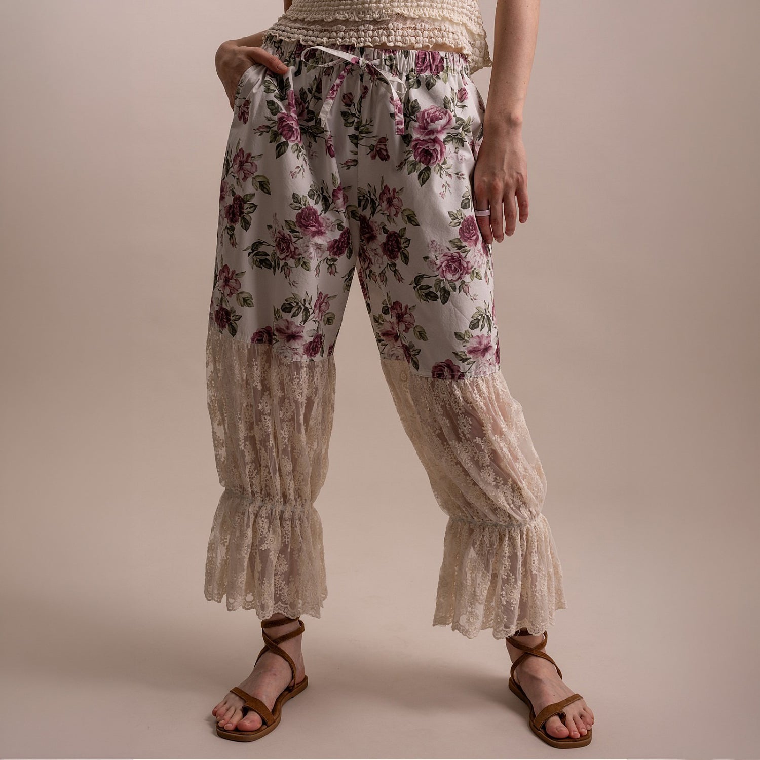 Bluevelvet women's off white floral pants, front view showing drawstring waist, lace lower panels, and ruffle cuff hem
