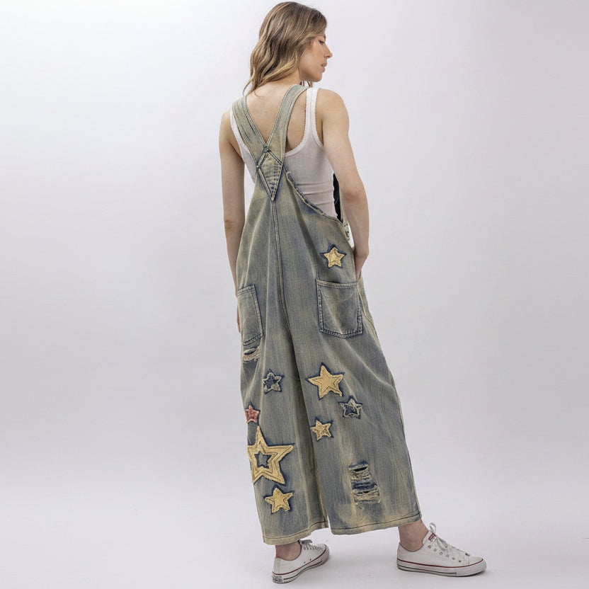 Bluevelvet women's wide-leg denim overall jumpsuit with star patchwork, three-quarter front view on model
