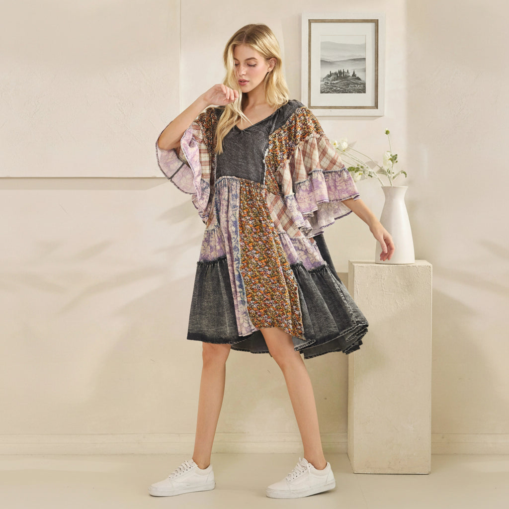 Woman wearing a patchwork dress with a neutral background