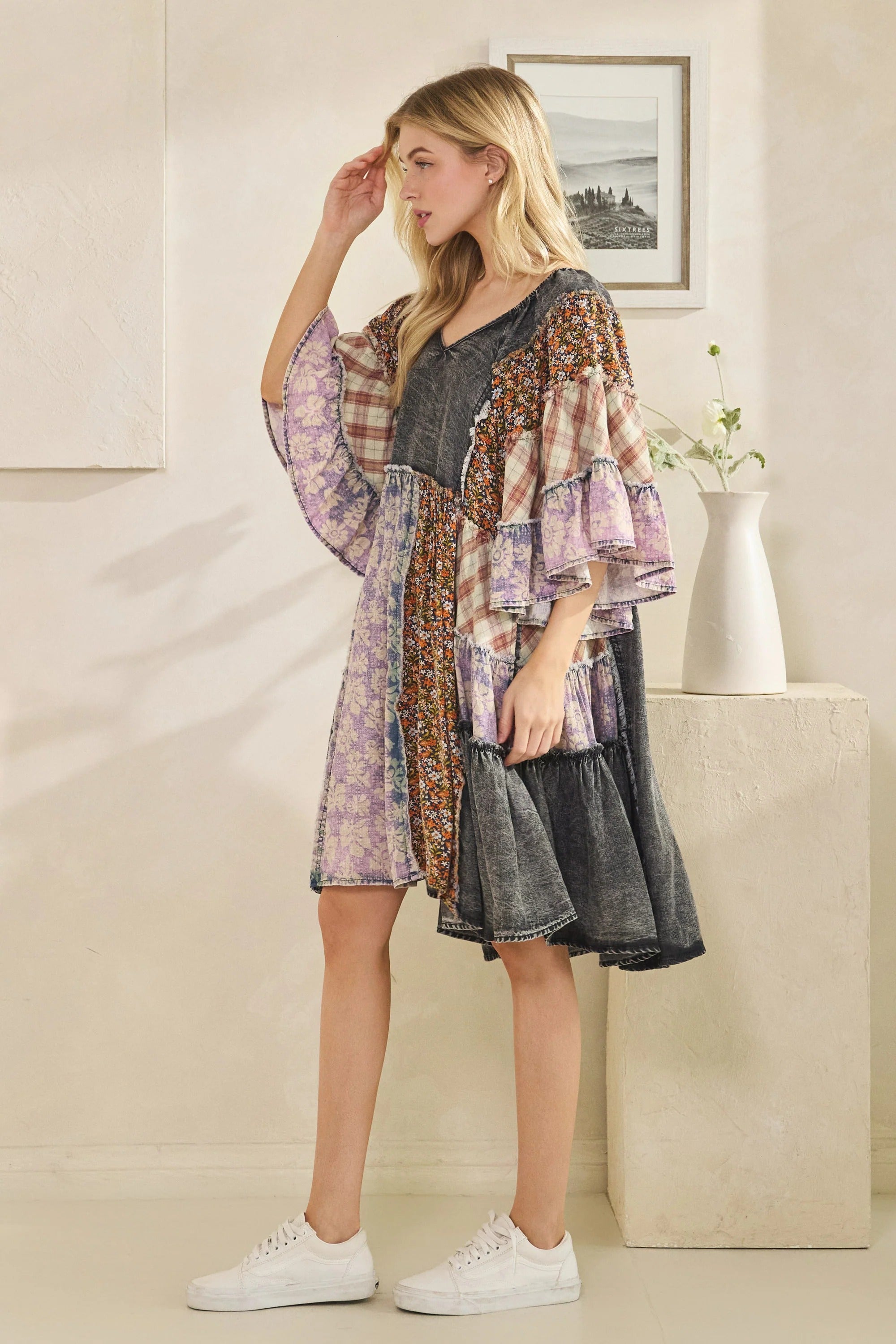 Woman wearing a patterned dress with a neutral background