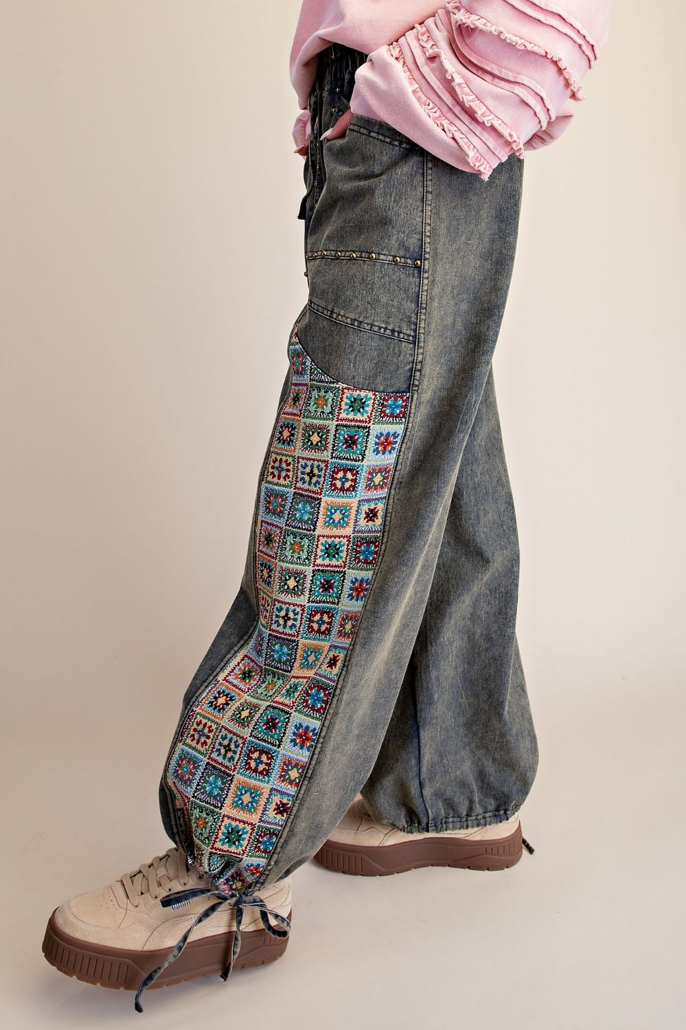 Easel Clothing dirty denim pants close-up detail showing oversized patch pockets with gold stud trim
