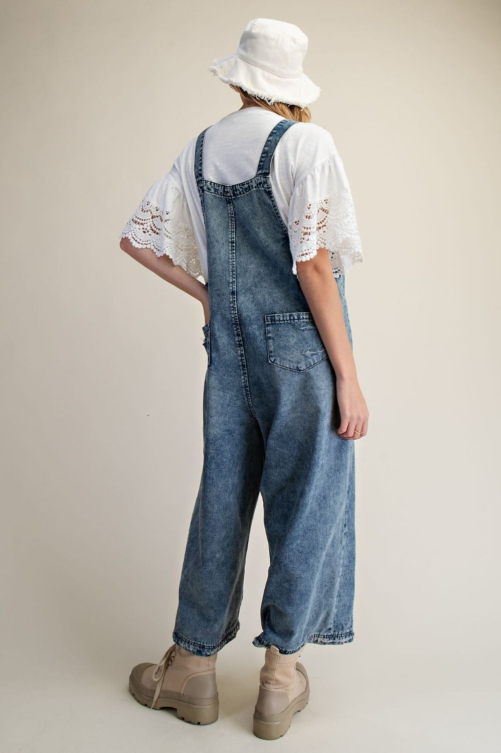 Easel Clothing vintage denim overalls close-up of front bib pocket and button straps