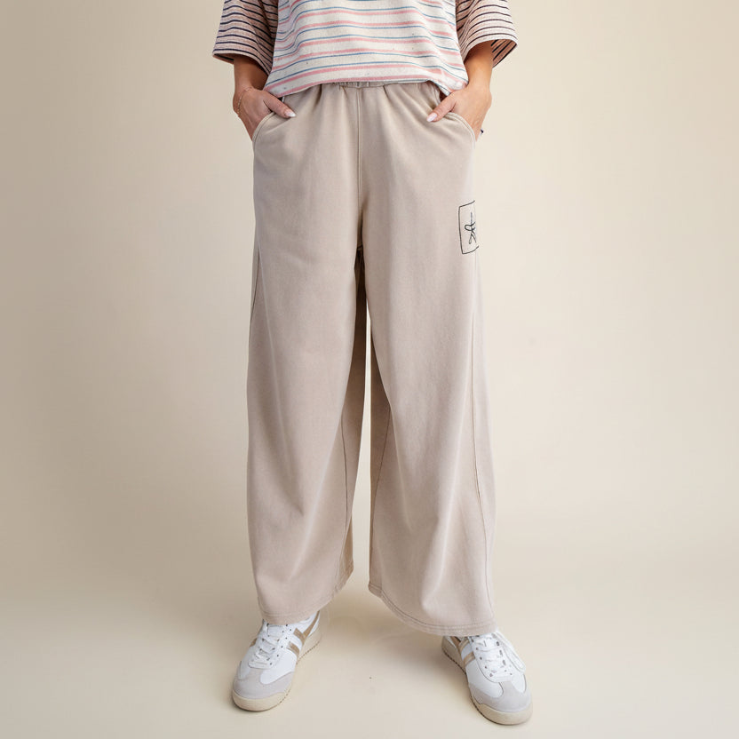 Easel khaki wide-leg pants front view, smocked elastic waistband, front pockets, and defined center seams
