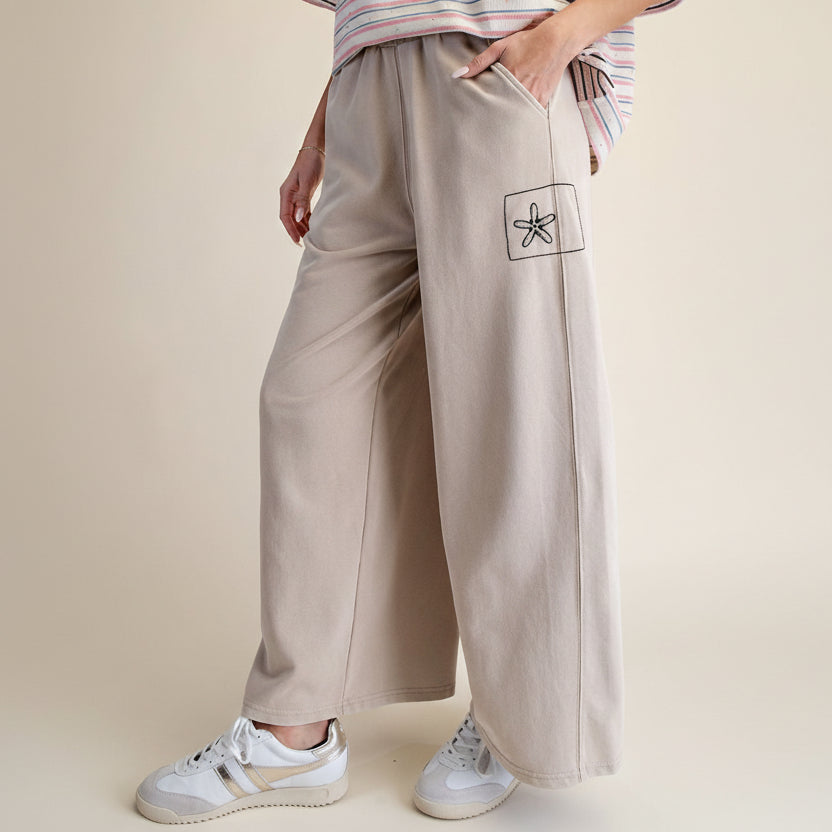 Easel khaki mineral wash wide-leg pants, close-up of starfish flower embroidery patch on side leg
