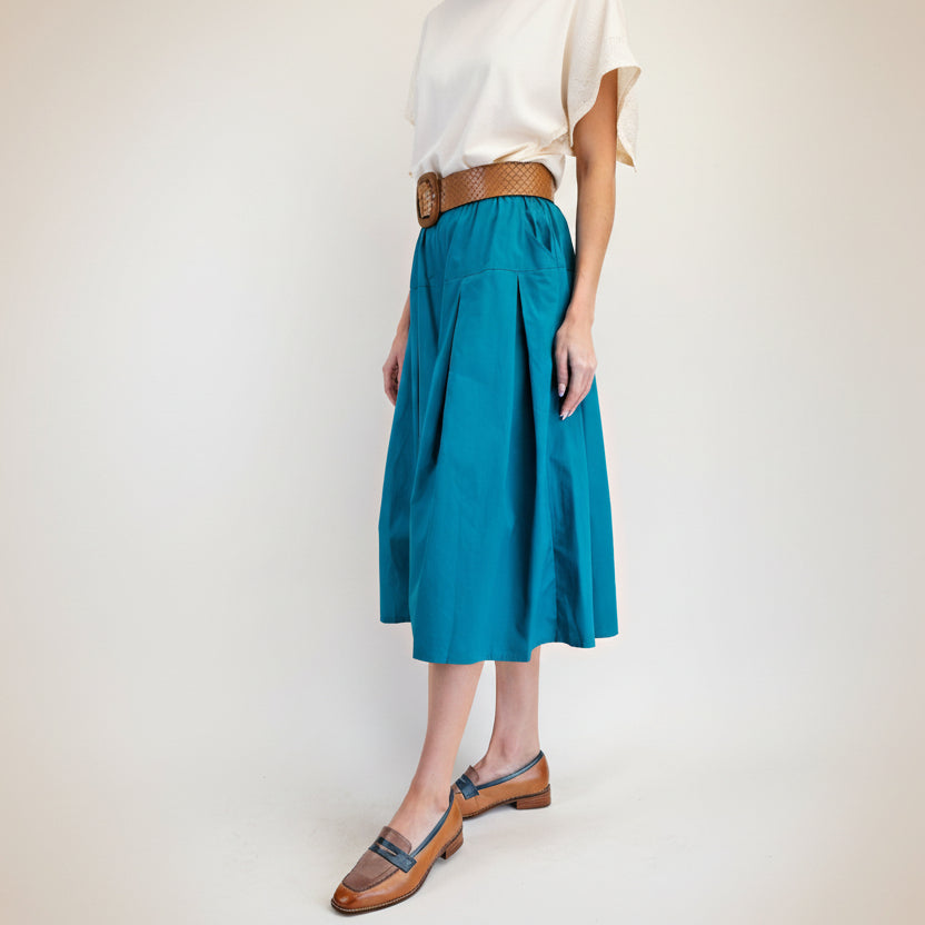 Easel teal pleated midi skirt side view showing full A-line volume and elastic waistband
