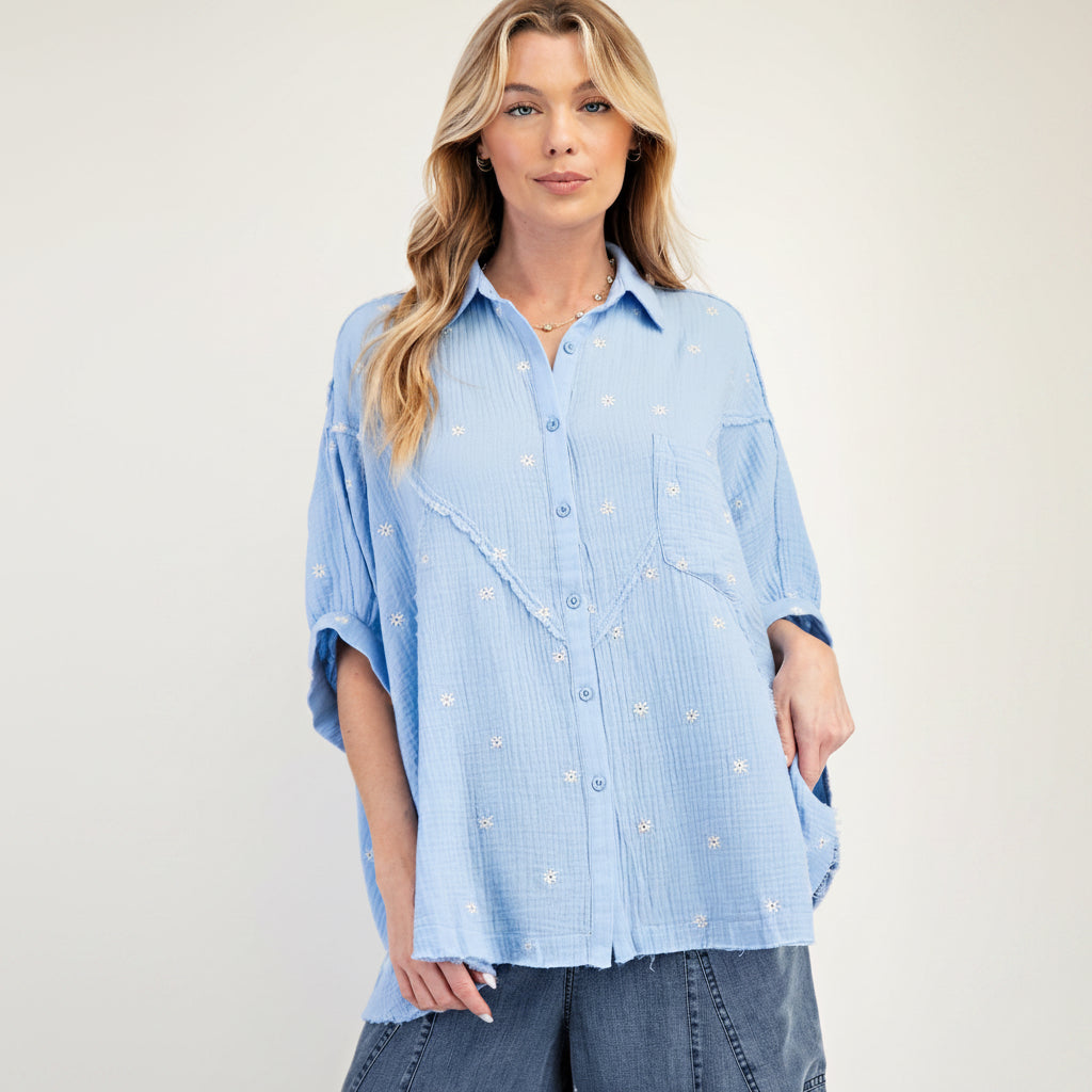 Easel women's sky blue embroidered gauze shirt, close-up front view, daisy embroidery and fringe pocket detail
