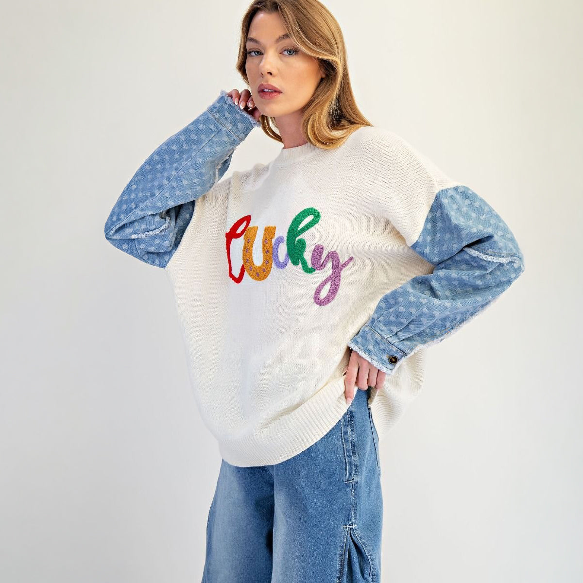 Ivory oversized knit sweater with multicolor lucky letter front graphic, front view