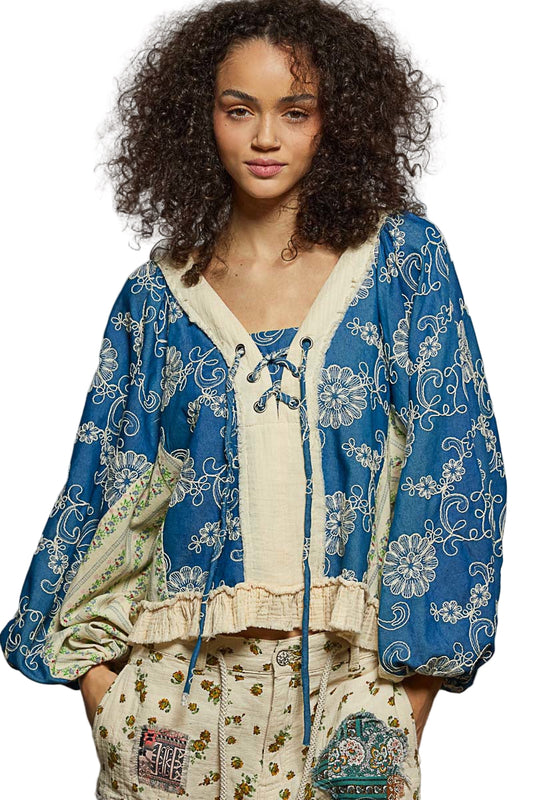 Woman wearing a blue and white patterned outfit with a white background