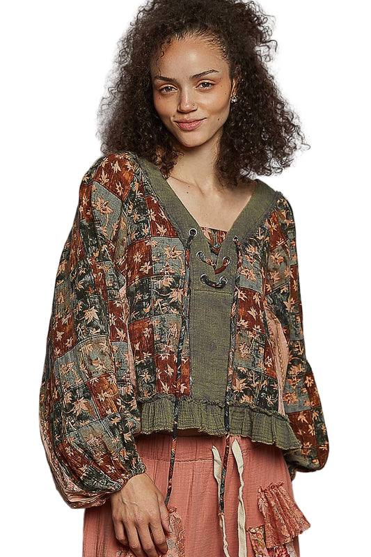 Woman wearing a patterned top with a plain background