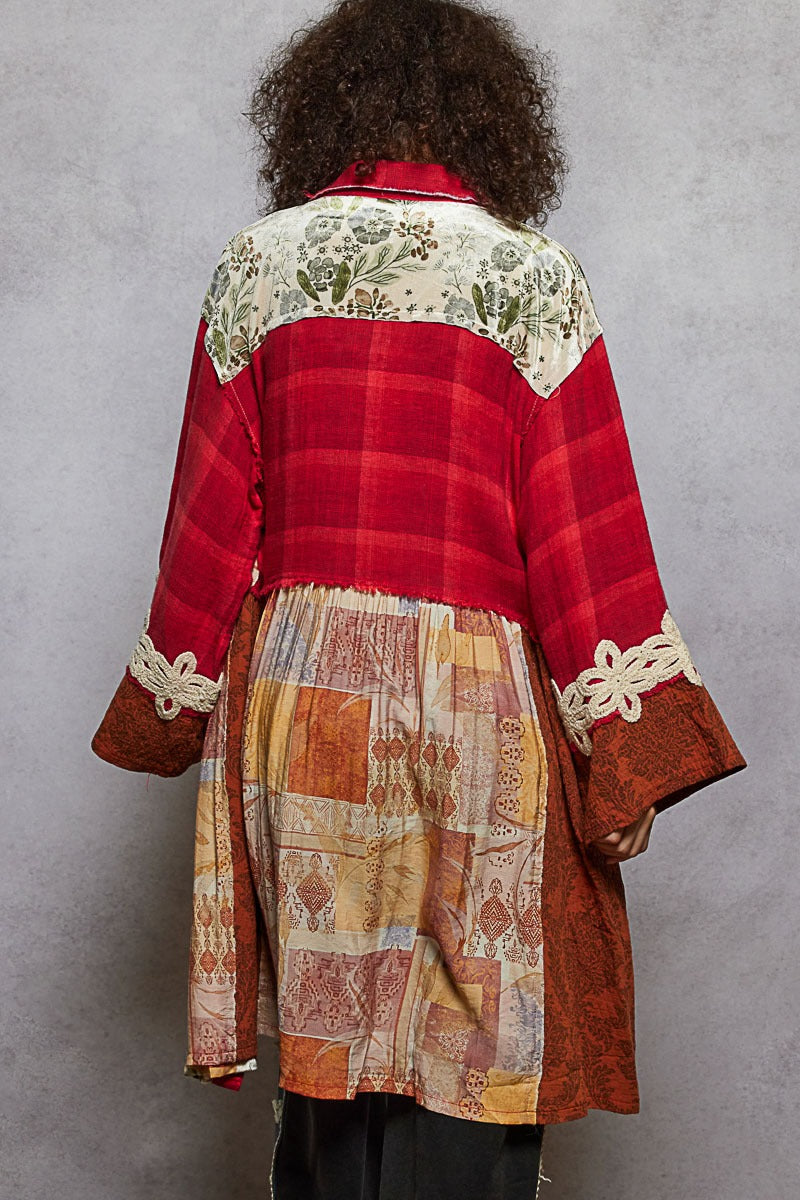 Red plaid coat with floral collar and patterned skirt on a gray background