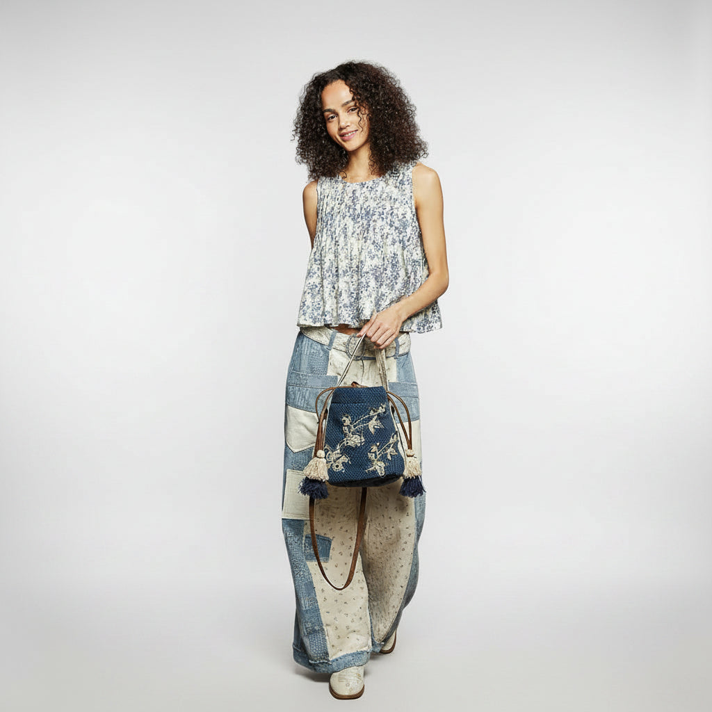 POL woven crossbody bag side profile, denim tone, gusset depth visible