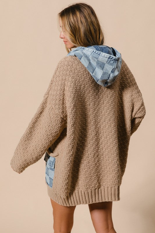 a woman is wearing a sweater and shorts