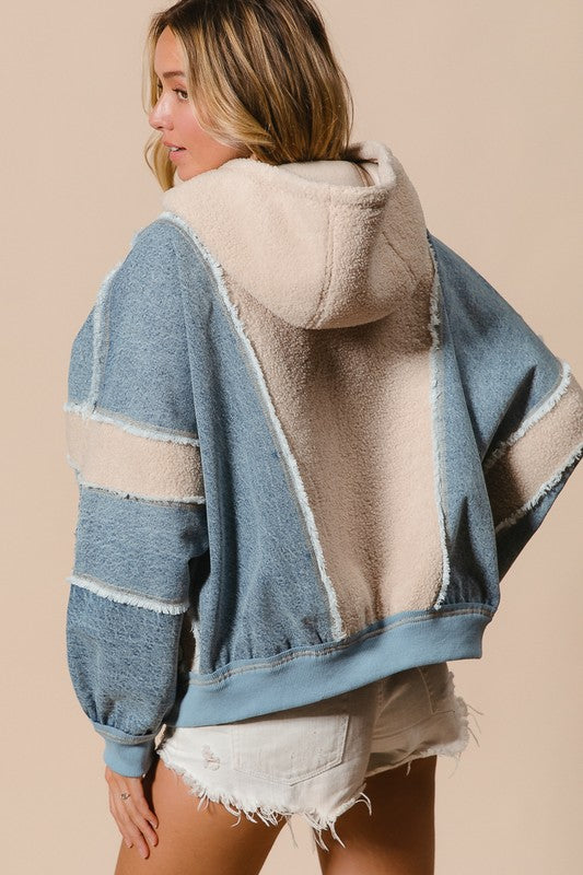 a woman wearing a blue and white jacket