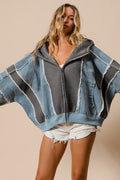 a woman wearing a denim gray jacket and shorts