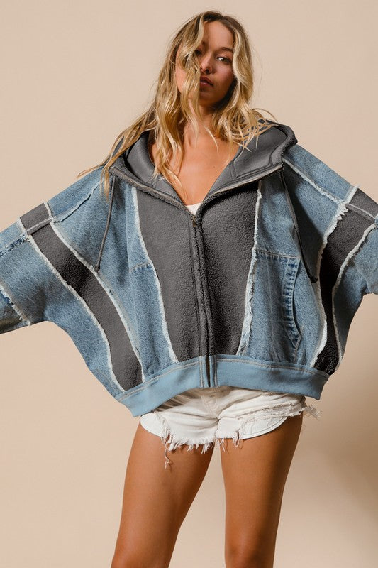 a woman wearing a denim gray jacket and shorts