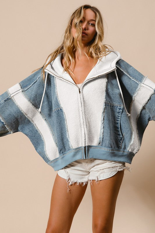 a woman wearing a denim ivory jacket and shorts