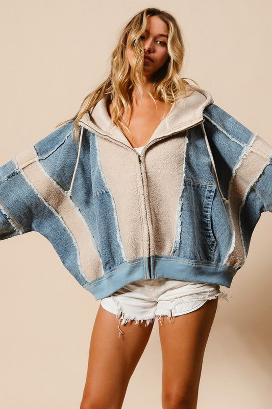 a woman wearing a denim beige jacket and shorts