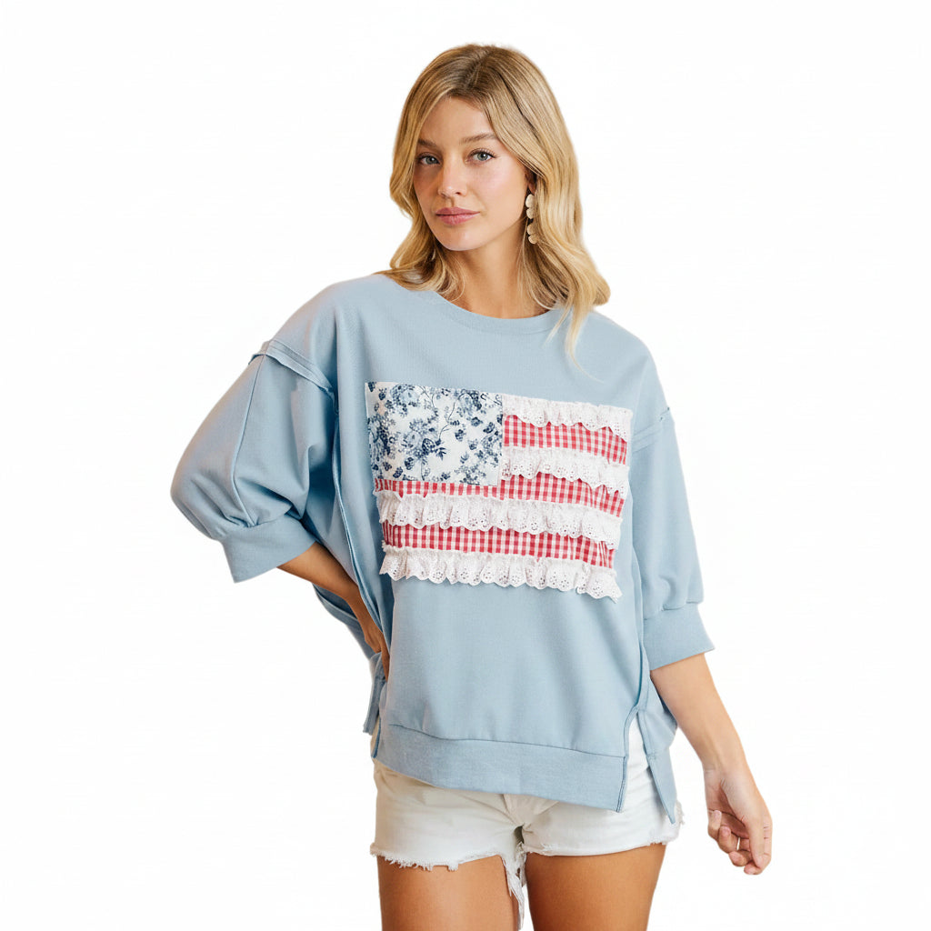 Women's light blue Americana patchwork French terry pullover top, lifestyle front view, relaxed oversized fit, drop shoulder