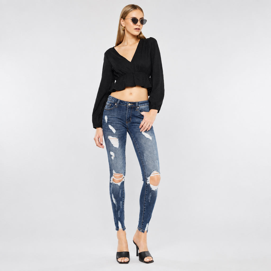 KanCan women's dark wash skinny jeans in a relaxed front pose showing thigh shredding and open knee rips