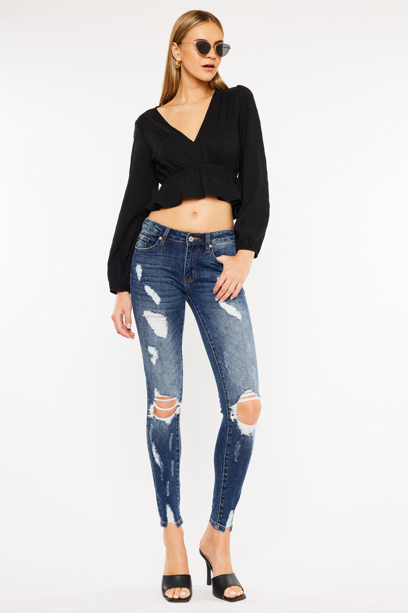 KanCan women's dark wash skinny jeans in a relaxed front pose showing thigh shredding and open knee rips