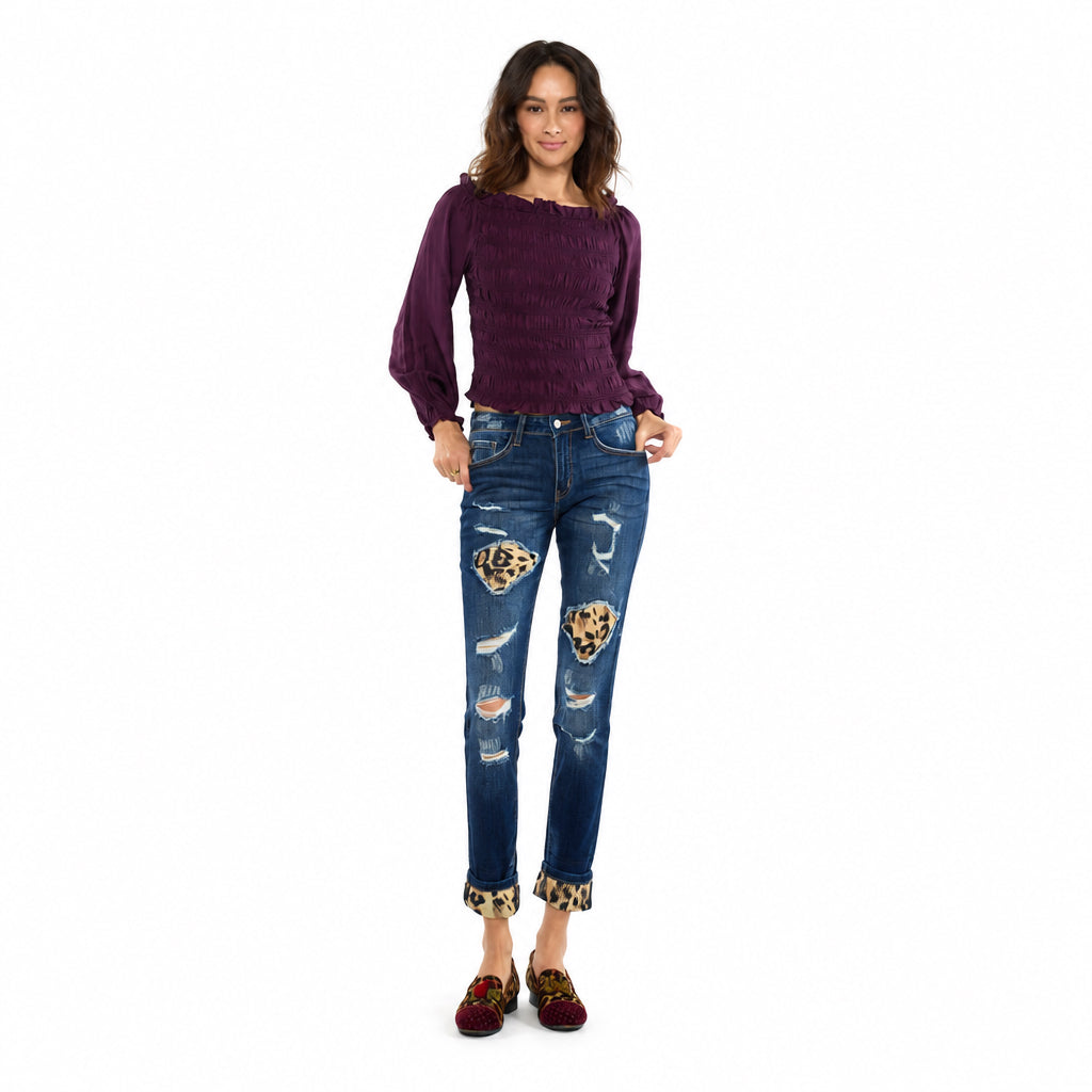 KanCan women's dark wash distressed skinny jeans with asymmetric leopard patches and folded cuffs, front view