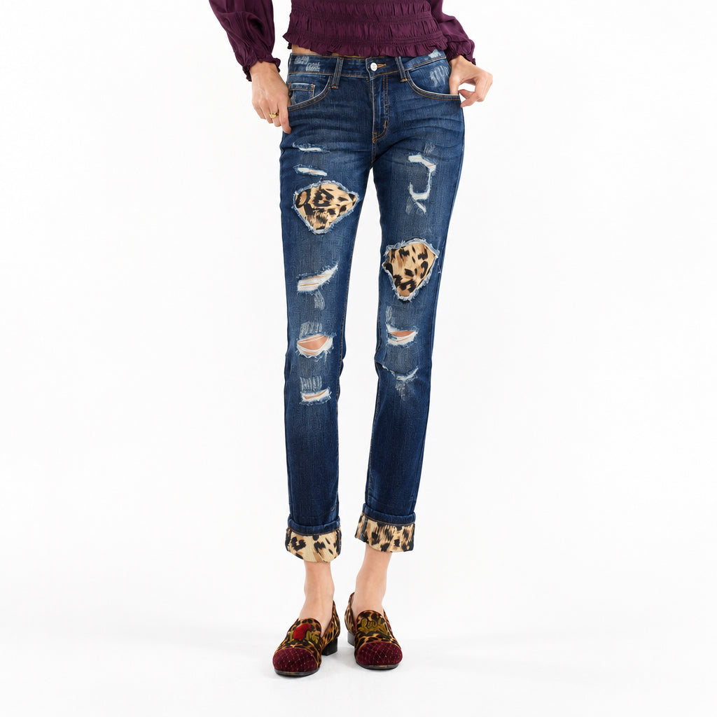 KanCan women's dark wash skinny jeans with leopard underlay patches, open frayed rips and cuffs, waist-to-feet view