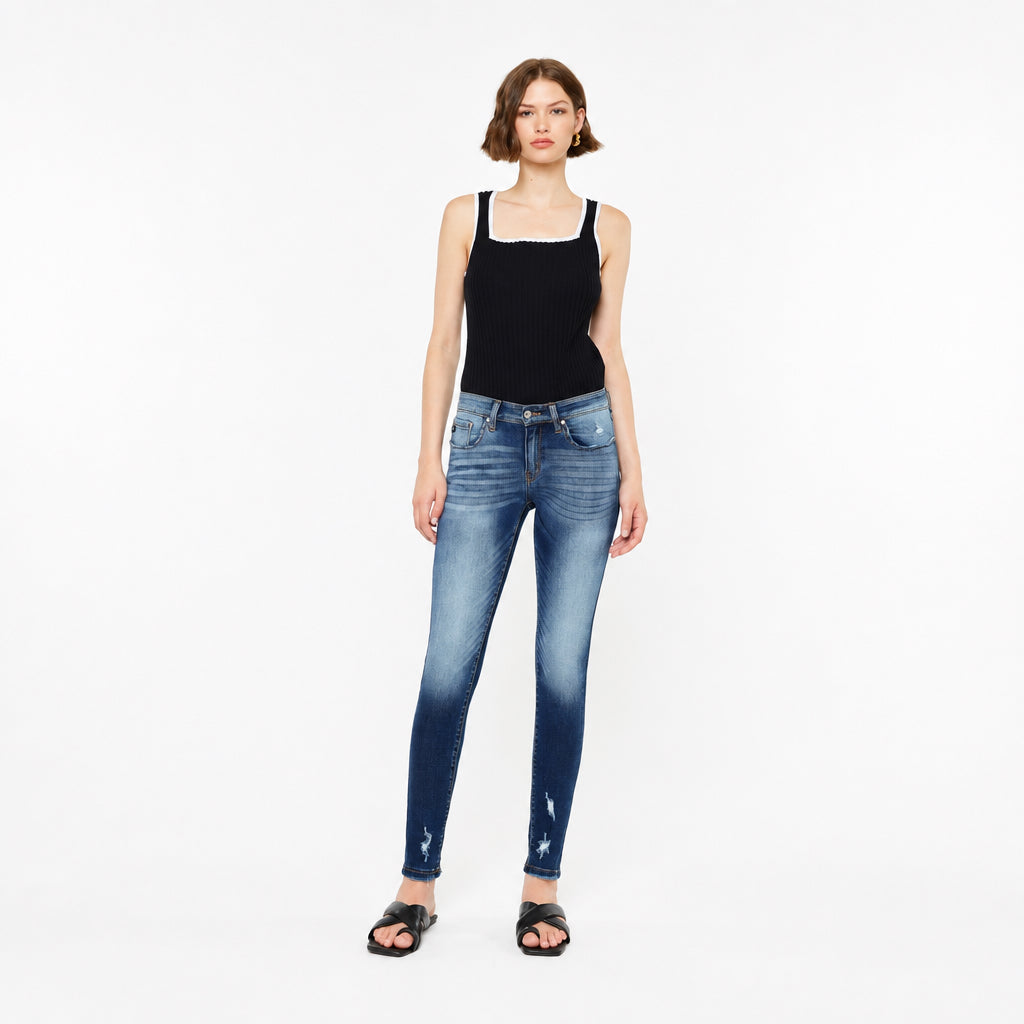 KanCan women's dark wash mid-rise super skinny jeans shown from a rear three-quarter angle
