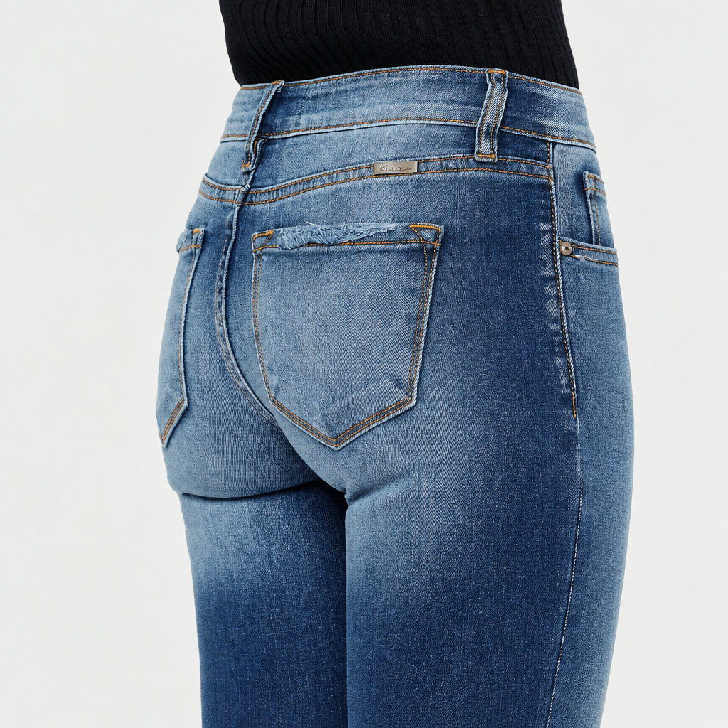 KanCan women's dark wash jeans rear pocket close-up showing faded denim, frayed edges and contrast stitching