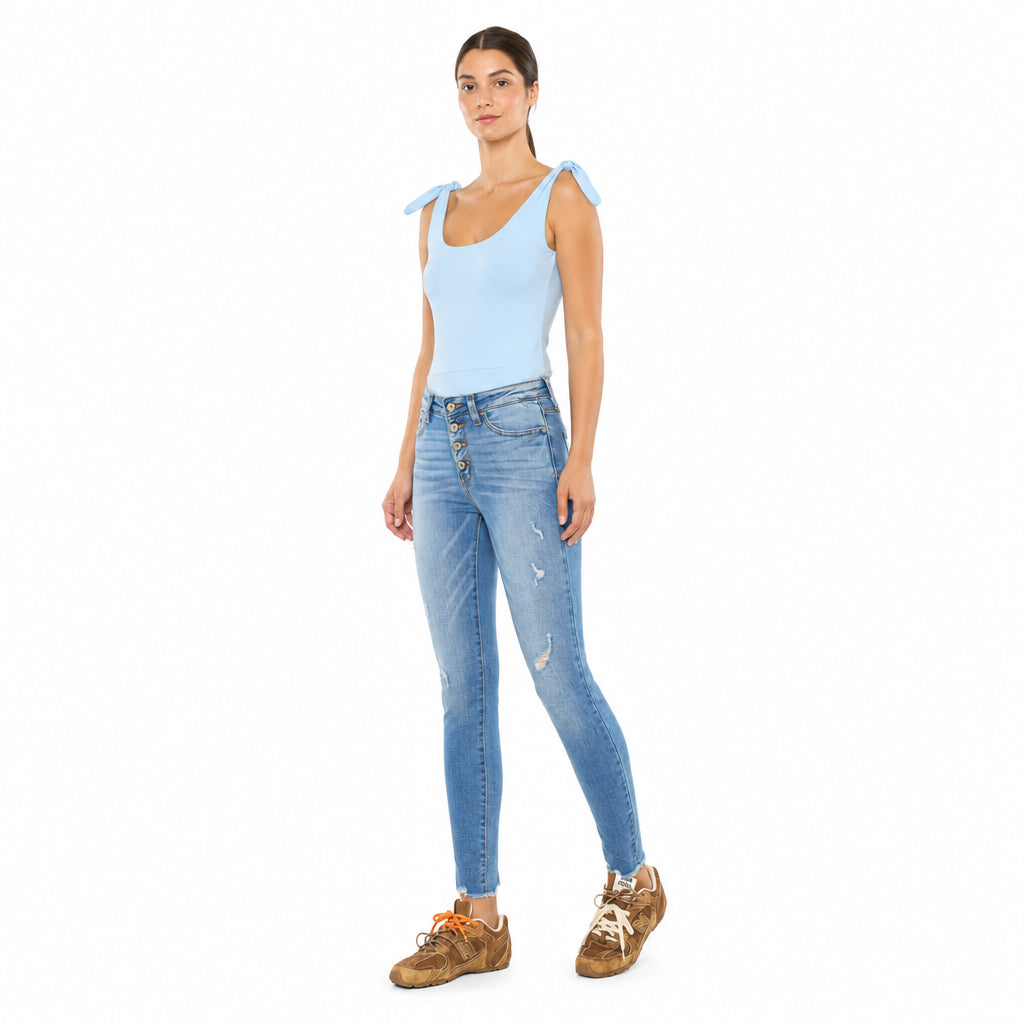 KanCan women's medium wash high rise skinny jeans, three-quarter front view showing distressed legs and ankle hems