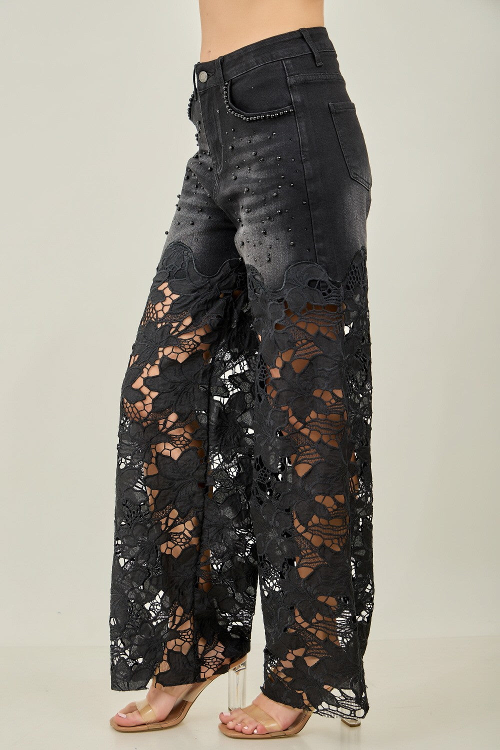 KIWI black wide-leg jeans with floral crochet lace panels on model, full-length side view
