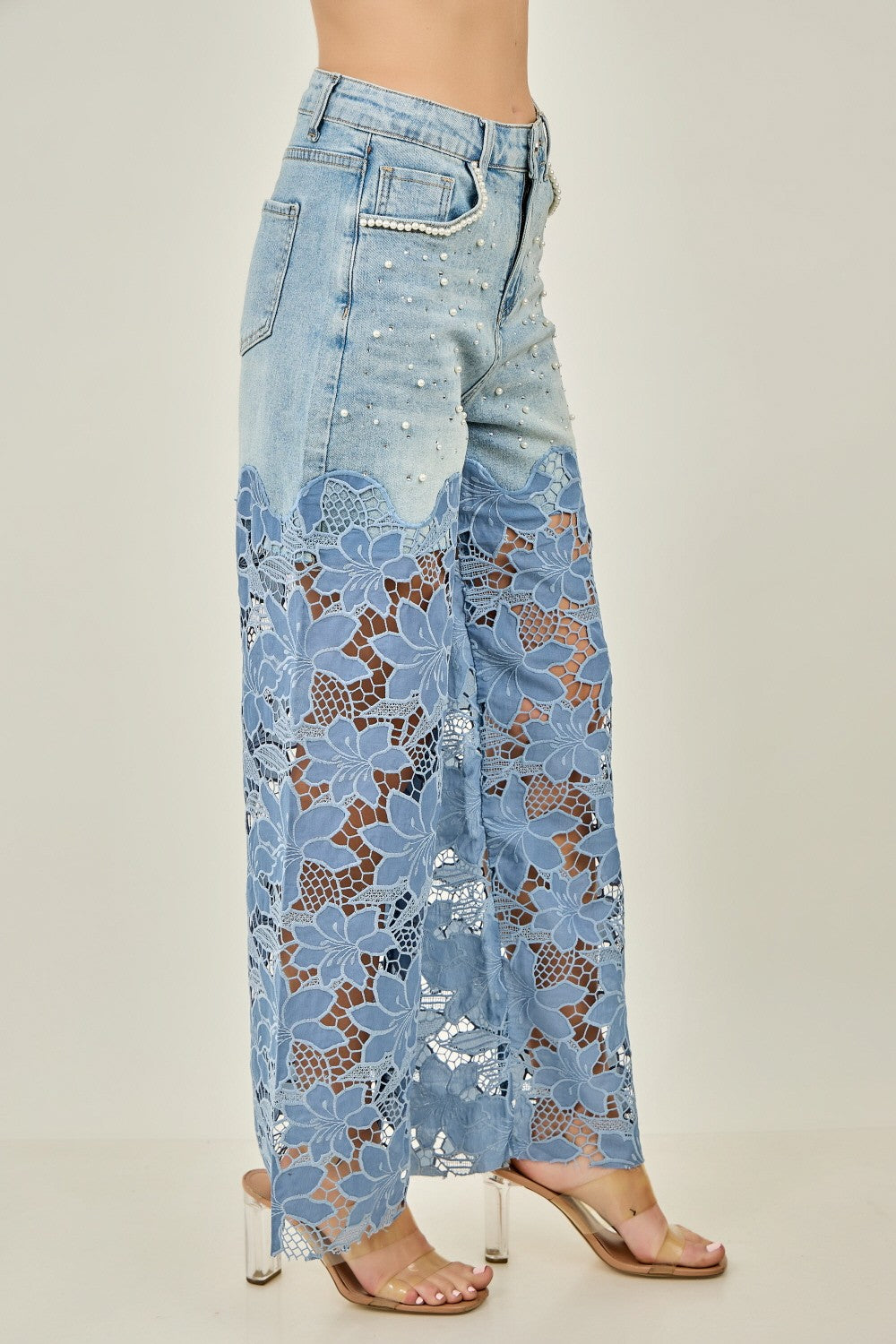 KIWI denim wide-leg jeans with pearl accents and lace panels on model, three-quarter view
