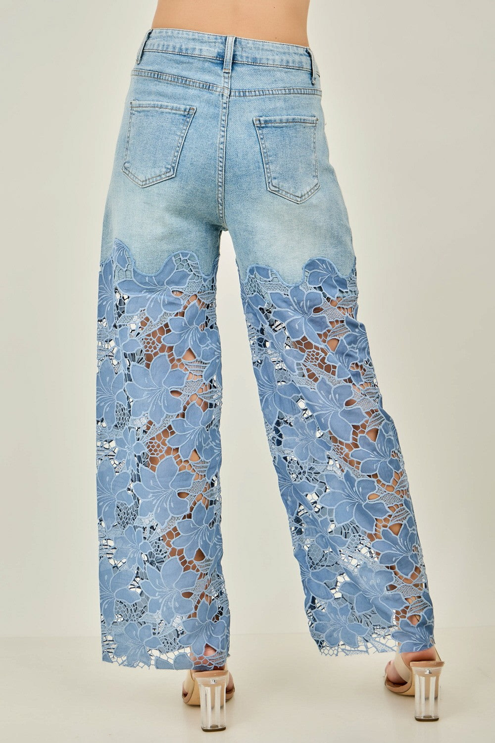 KIWI denim wide-leg jeans showing floral crochet lace lower leg panels, full-length side view
