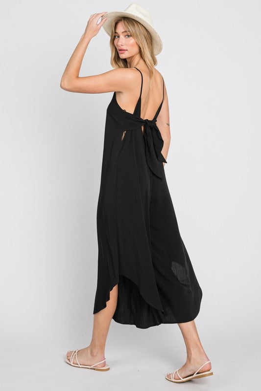 a woman wearing a black dress and hat