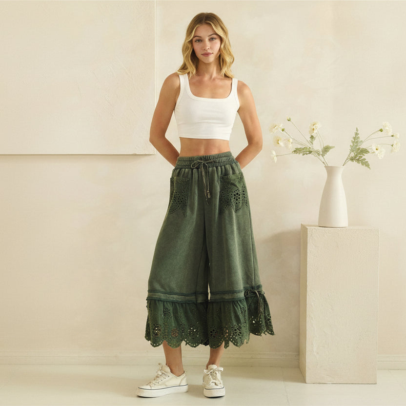 Oli & Hali teal green mineral-wash wide-leg pants on model, full-length front view with eyelet lace pockets

