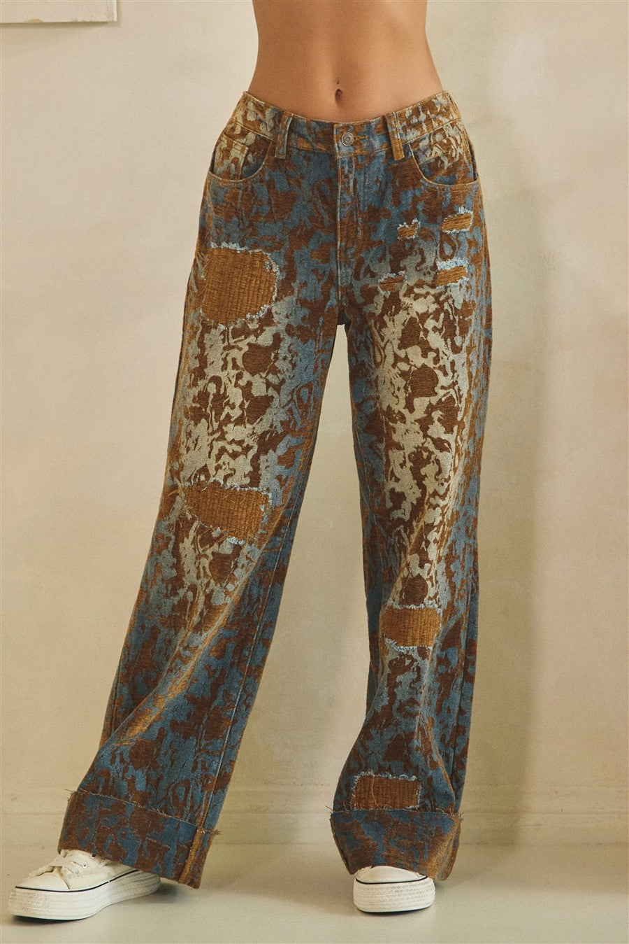 Brown denim burnout wide-leg pants on model, three-quarter side view showing wide-leg silhouette and cuffed hem

