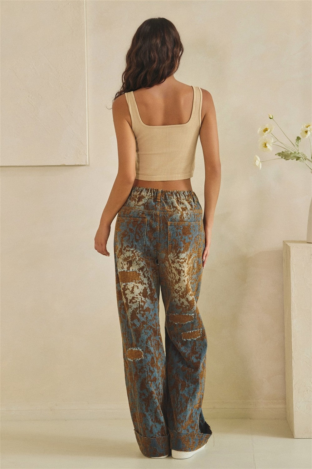 Women's brown denim mineral-wash burnout wide-leg pants on model, front-facing full-length view
