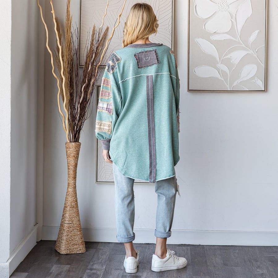 Oli & Hali sage patchwork pullover top, back view showing center seam and mixed textile sleeve patches
