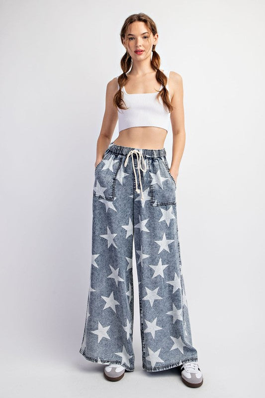 a woman wearing a crop top and wide legged pants