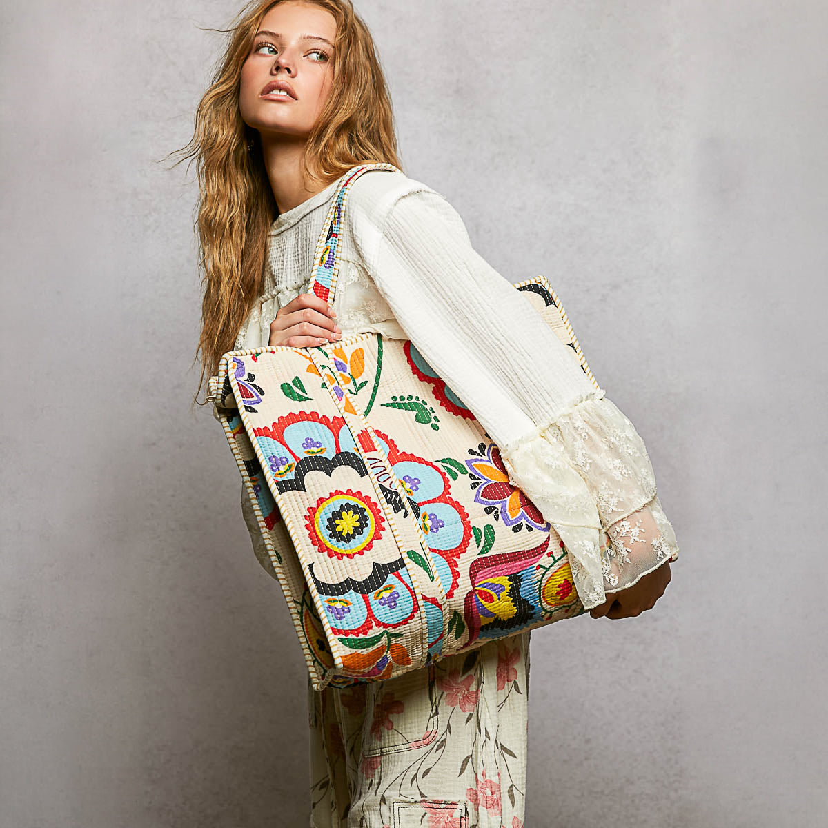 POL Clothing women's Cream Multi quilted tote with colorful folk print carried at her side