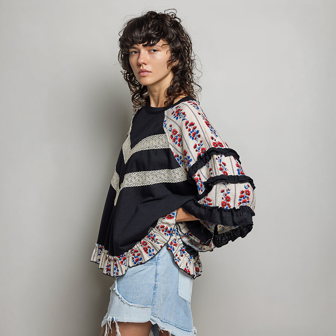 POL Clothing women's oversized black knit top back view, tiered floral ruffle raglan sleeves