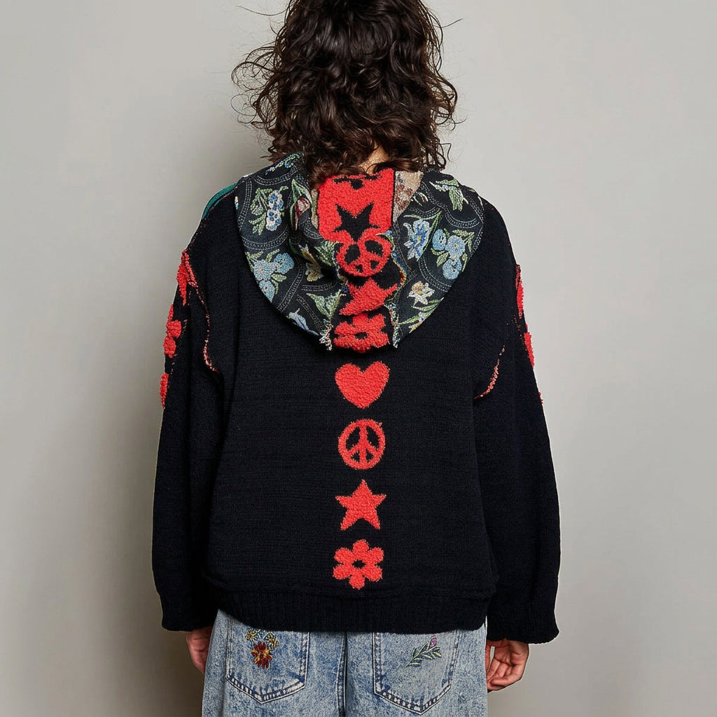 POL Clothing black hoodie sleeve detail with raised coral star, flower, heart and peace-sign appliqués